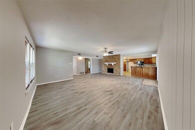 Unfurnished living room featuring a textured ceili