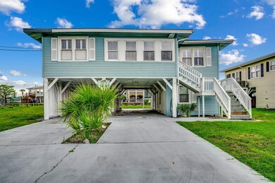 Beach home with a carport and a front lawn