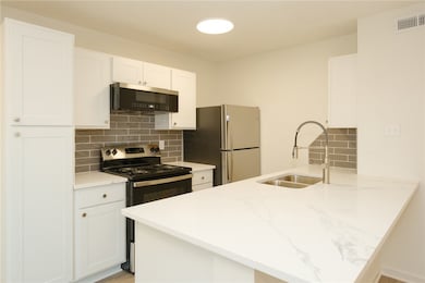 Kitchen featuring stainless steel appliances, back