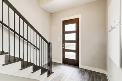 Light filled entry with hardwoods & staircase to 2