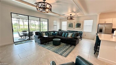 Tiled living room featuring a notable chandelier, 