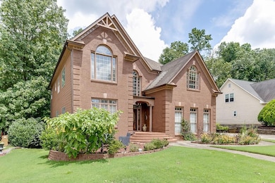 View of front of house with brick siding and a fro