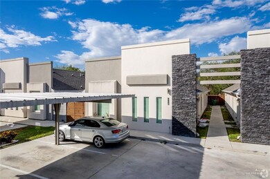 View of building exterior with covered parking
