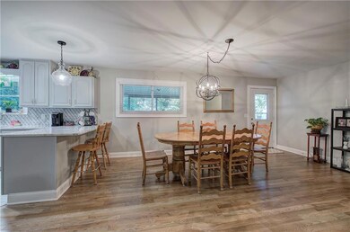 Dining space featuring a notable chandelier and ha