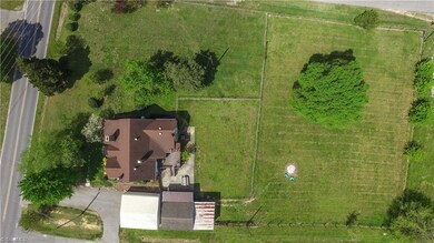 Two separate fenced in areas with large shade tree
