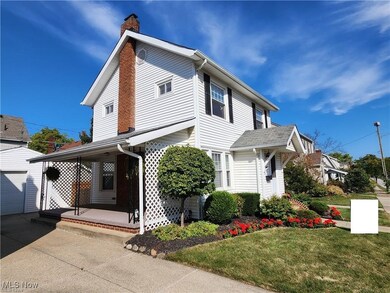 View of front of house featuring a front yard, a garage, and a porch