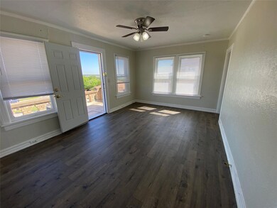 Unfurnished room with ceiling fan, ornamental molding, plenty of natural light, and dark hardwood / wood-style floors