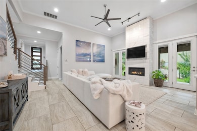 Living room featuring ceiling fan, a fireplace, s