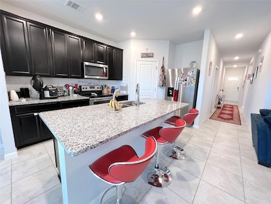 Kitchen with stainless steel appliances, dark cab