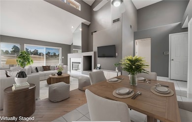 Dining space featuring visible vents, a high ceili