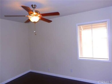 bedroom #2 with new ceiling fan and wood floors