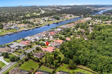 Aerial overview of property's location with a nearby body of water and nearby suburban area