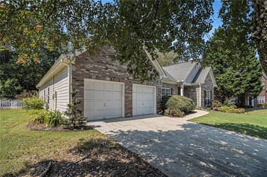 View of front of property with brick siding, concrete driveway, and an attached garage