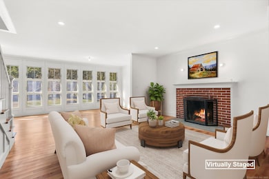 Virtually staged sun-filled living room.