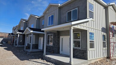 View of side of property featuring stone siding, board and batten siding, and stucco siding