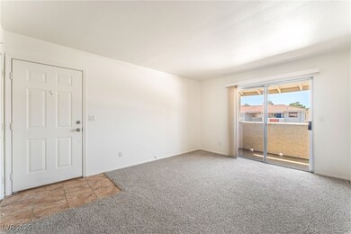 Carpeted spare room featuring baseboards