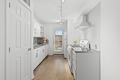 Galley shaped kitchen with glass door that leads t