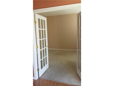 French doors lead to a formal Living Room that can