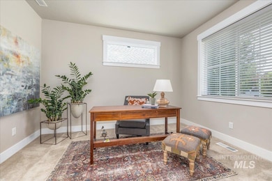 Carpeted office space with healthy amount of natural light
