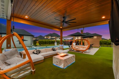 The outdoor pergola features a cozy fire pit, providing warmth and ambiance for gatherings. Take note of the stunning stained wood ceiling, complete with a ceiling fan and recessed lighting. This combination of natural elements and modern amenities creates an inviting and comfortable outdoor space, perfect for enjoying evenings with family and friends year-round.