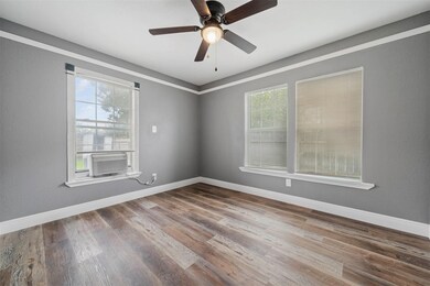 This room features sleek gray walls, wood-style fl