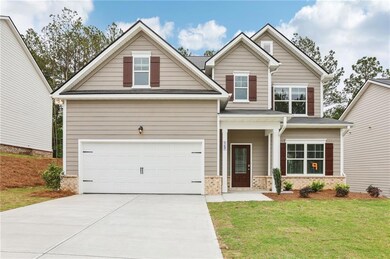 Craftsman house with concrete driveway and a front lawn