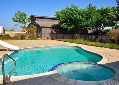 Gated pool with a slide and spa.