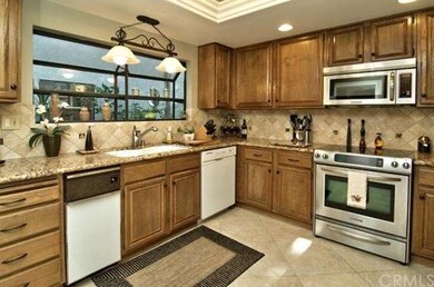Kitchen with granite counter tops and tumbled ston