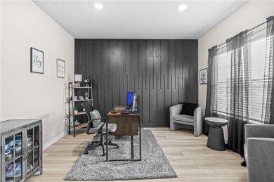 Home office featuring an accent wall, light wood-style flooring, recessed lighting, and baseboards