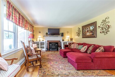 Living room with wood burning fp and original hardwoods