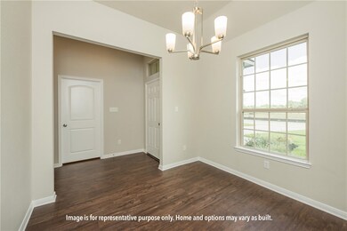 Unfurnished dining area featuring dark wood finished floors and a chandelier