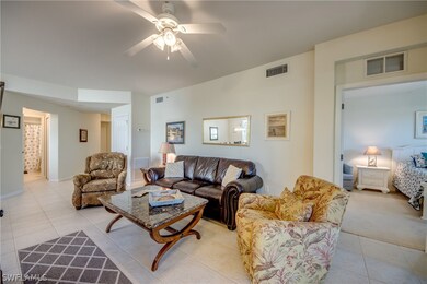 Living room featuring light carpet and ceiling fan