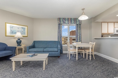 Living room with a textured ceiling and carpet flo