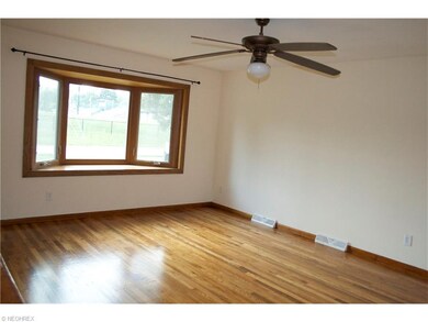 large living room with bay window and refinished h