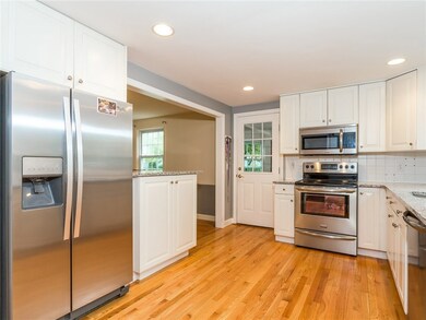 Kitchen that has a breakfast bar into dining room
