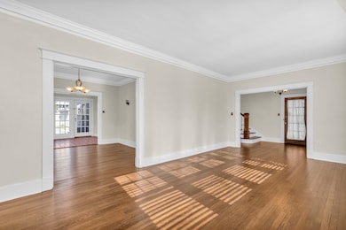Living room to dining room and entry view.