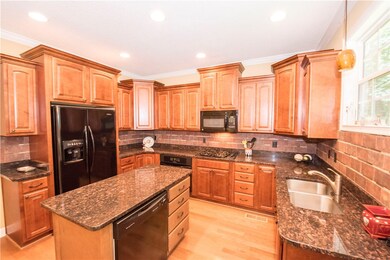 Kitchen with center island and granite countertops