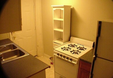 Kitchen with a sink and white appliances