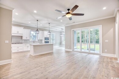 Kitchen featuring gas stovetop, a center island, h