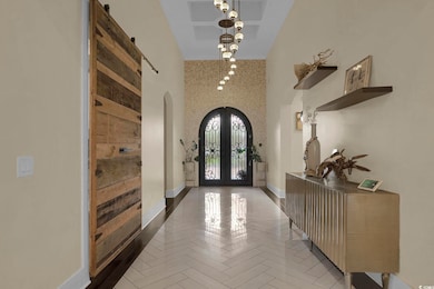 Foyer entrance featuring arched walkways, french doors, and a high ceiling