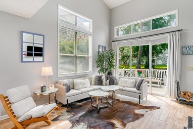 Living room featuring high vaulted ceiling and lig