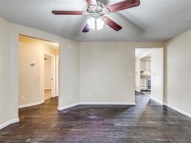 Empty room with dark hardwood / wood-style floors and ceiling fan