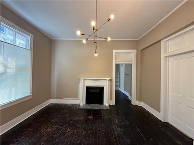Unfurnished living room with baseboards, ornamenta