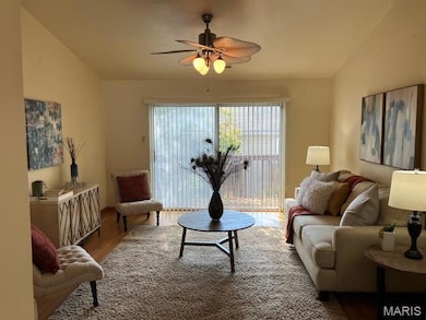 Living area with wood finished floors and a ceiling fan