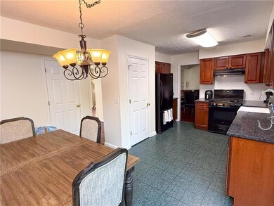 Kitchen featuring visible vents, black appliances,