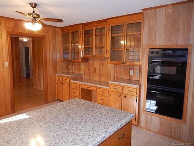 Kitchen with large eating area and glass front cab
