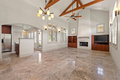 Unfurnished living room with high vaulted ceiling