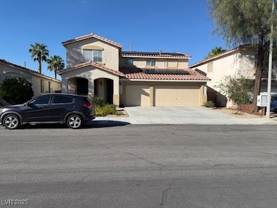 Mediterranean / spanish-style house with solar panels, a garage, a tile roof, and concrete driveway