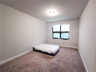 Carpeted bedroom featuring baseboards