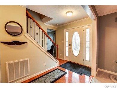 Enter through a hardwood and wrought iron Foyer